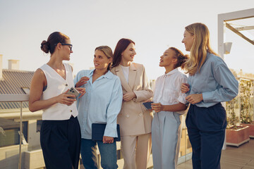 A group of women actively engaging in an enriching conversation while on a rooftop setting