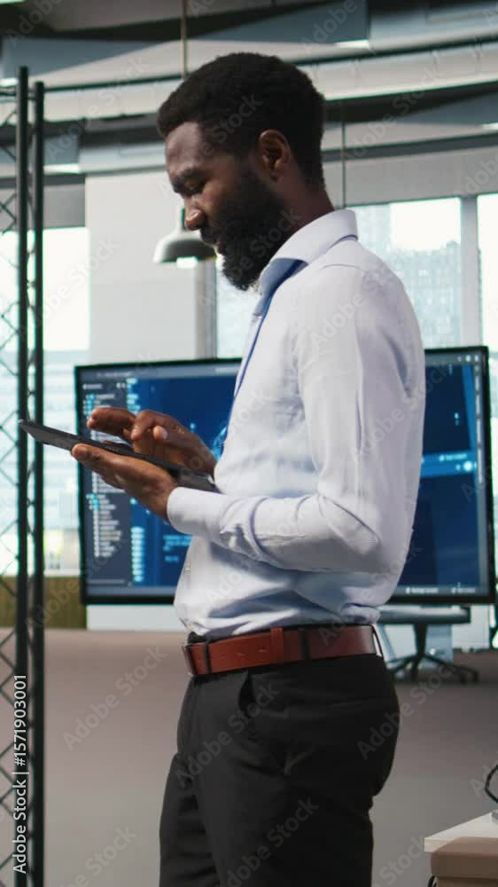 Poster vertical video joyous technician in office automating repetitive tasks using ai scripts. upbeat man 