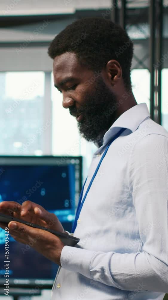 Poster vertical video joyous technician in office automating repetitive tasks using ai scripts. upbeat man 