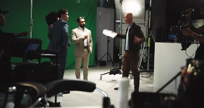 Man, angry director and movie producer with script, green screen and behind the scenes with conflict. People, film crew and throw paper for cinematography mistake, recording or actor with wrong lines