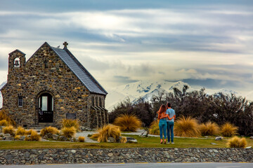 Unrecognisable lovers at the famous church of the good shepherd at Lake Tekapo