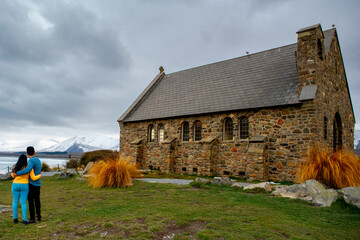 Unrecognisable lovers at the famous church of the good shepherd at Lake Tekapo
