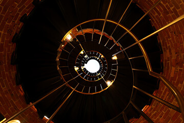 Spiral Staircase Ascending to Light in a Brick Lighthouse Interior