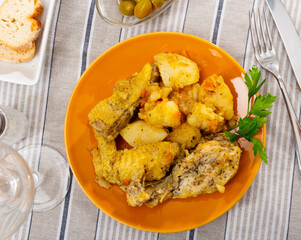 Delicious baked chicken pieces with side dish of home-style stew potatoes served for dinner..