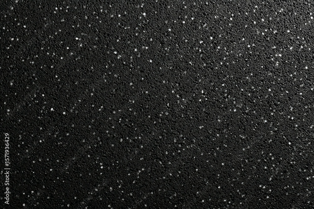 Poster close-up of black textured surface with sparkling patterns and highlights