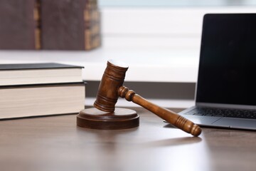 Judge. Laptop, gavel and books on wooden table in office