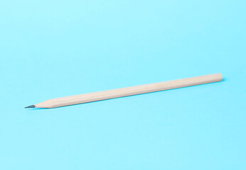 One graphite pencil on light blue background, closeup