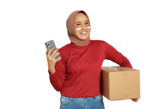 Excited young Asian women celebrate Indonesian independence day on 17 August while holding cardboard boxes and smartphone isolated on transparent background - Powered by Adobe