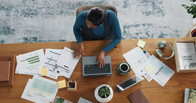 Top view, laptop and business woman typing in office for accounting document or investment. Above, computer and African worker writing report for bookkeeping, financial performance or budget proposal