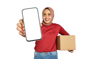 Happy young Asian women celebrate Indonesian independence day on 17 August while holding smartphone with blank screen and cardboard boxes isolated on transparent background