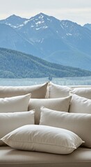 Serene Mountain View from a Cozy Couch with Plush White Pillows