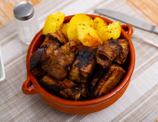 Roasted pork ribs with BBQ sauce served with potato
