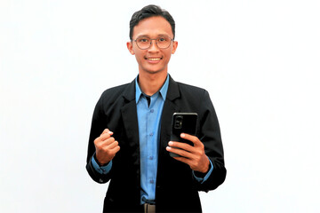 A business Asian man holding a cellphone with a happy expression