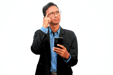 An Asian business man holding a cell phone with a thoughtful expression.