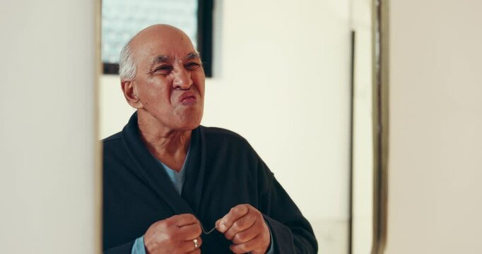 Senior man, mirror or teeth with dental floss for cleaning cavity, mouth or gum care in bathroom. Elderly, male person or smile with string or reflection for tooth hygiene or food removal in home