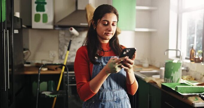Phone, reading and remodeling with woman in kitchen for subcontractor research, project and paint idea. Home improvement, renovation and DIY supplier contact with person in house for communication