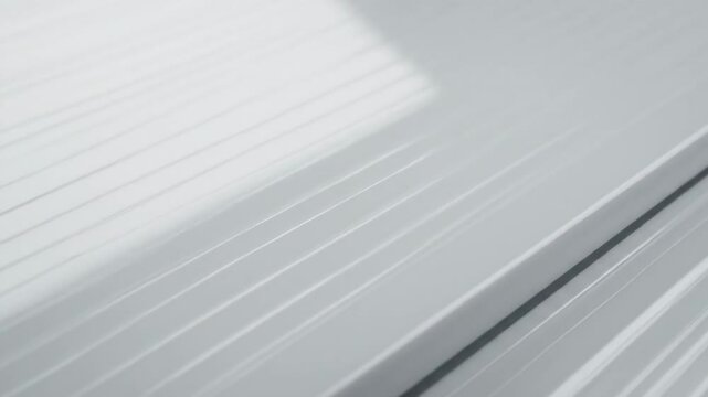 Closeup of a smooth ribbed bright white surface with subtle shadows