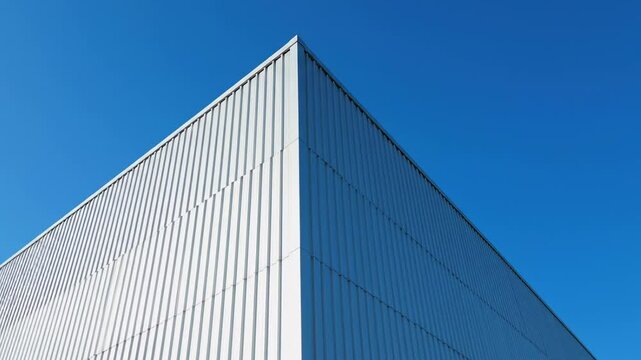 Silver metal building corner against a clear blue sky