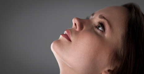 Close up portrait of a beautiful model posing with hope and faith, thinking and dreaming