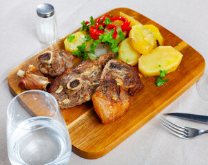 Roasted lamb leg served with grilled organic vegetable and peppe