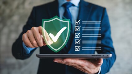 Businessman holds tablet displaying shield with check mark and completed tasks