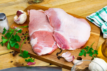 Raw slice of Iberian pork secret and parsley in restaurant