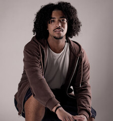 Studio portrait of a stylish young african american man crouching and posing