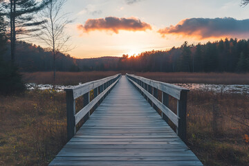Obraz premium a wooden bridge over a lake at sunset