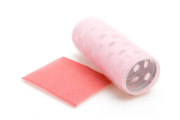 Pink Self-Adhesive Hair Roller for Voluminous Hairstyling and Bangs Isolated on White Background