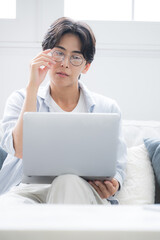  パソコンを見ながら考える男性困る悩むの表情