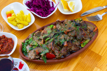 Main Turkish dish tirit and meze small dishes served on festive table.