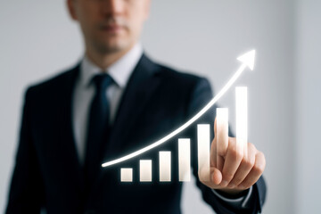 Businessman touching glowing upward trend graph suit white shirt