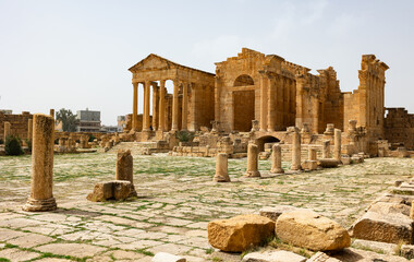 Monumental Capitoline Temples of Sufetula surrounded with stone ruins in Tunisia