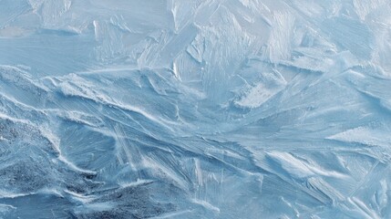 Intricate patterns of frozen ice on a tranquil lake surface captured during winter's embrace