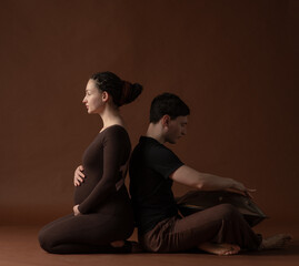 pregnant woman in yoga pose next to man playing percussion