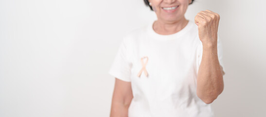 Elderly woman with Peach Ribbon for September Uterine Cancer Awareness month, Endometrial Cancer,...