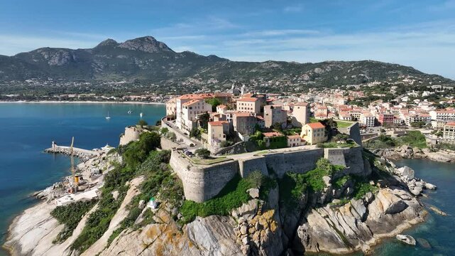 Fortress Perched on Rocky Coast in Corsica Surrounded by Blue Bay