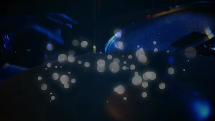 Drummer striking cymbal under red-blue lights and causing sparks intensifying then fading for show