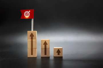 Wooden Blocks Climbing to Red Flag Target Representing Business Goal