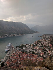 Scenic high angle view of a European coastal town on a bay with a cruise ship. Historic city with...