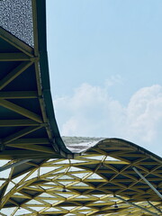 Abstract view of a modern canopy with a yellow geometric frame. Architectural details of a...