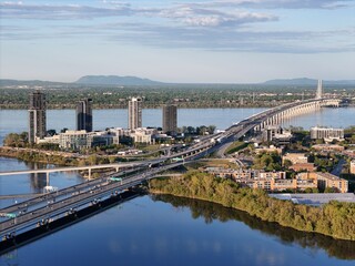 Nuns' Island residential buildings, bridge, and traffic at the sunset, Montreal, Quebec, Canada...
