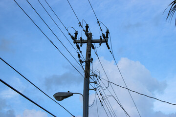 electricity pylon against blue sky