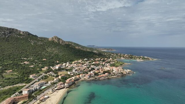 Aerial View of Mediterranean Village With Coastal Cliffs and Azure Waters