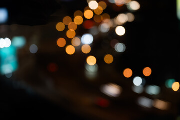Night shows reflection from cars tail lights and street lighting on road. Abstract background for...