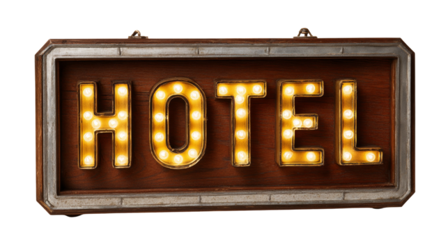 Illuminated hotel sign with warm glowing lightbulbs is attached to rustic frame.