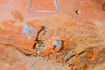 Excavator is digging moving earth on construction site preparing for foundations under works day