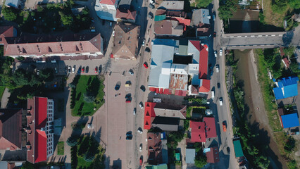 Charming small town streets with colorful rooftops and busy local traffic in daylight
