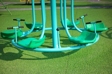 Playground Equipment Featuring Colorful Carousel Under Sunny Sky
