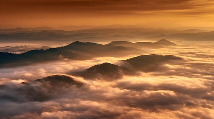Fototapeta premium A breathtaking misty mountain landscape at sunrise where a sea of clouds fills the valleys below and distant peaks stand tall their silhouettes glowing in the warm golden light of the new day